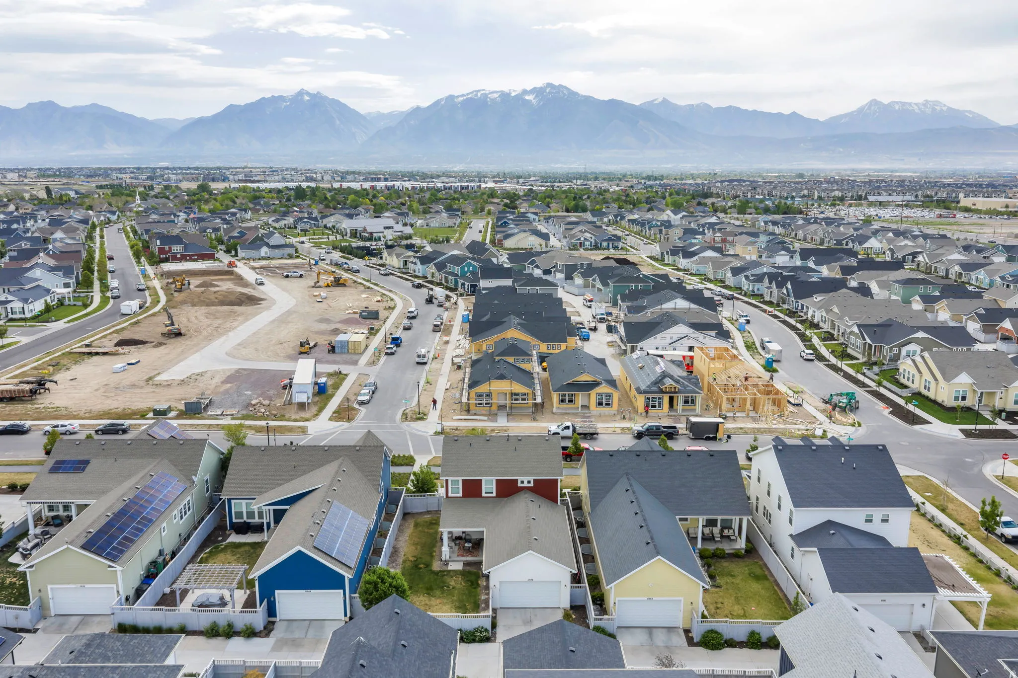 Expansive residential development featuring numerous single-family homes with varying rooflines and exterior finishes