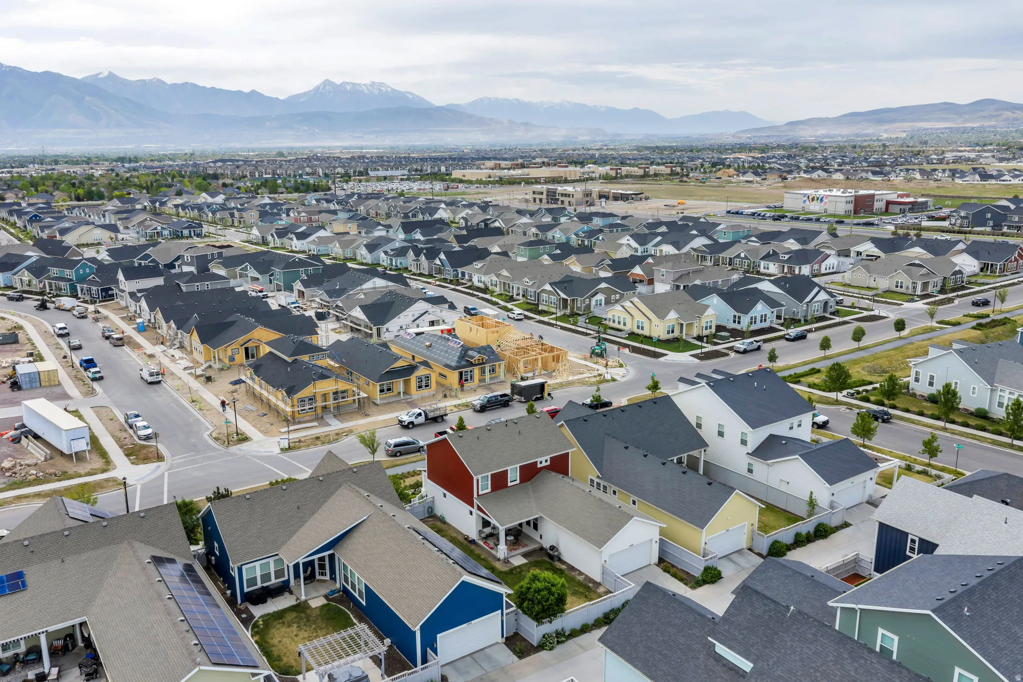 Aerial perspective showcasing a residential community with varied architectural styles and mountain scenery