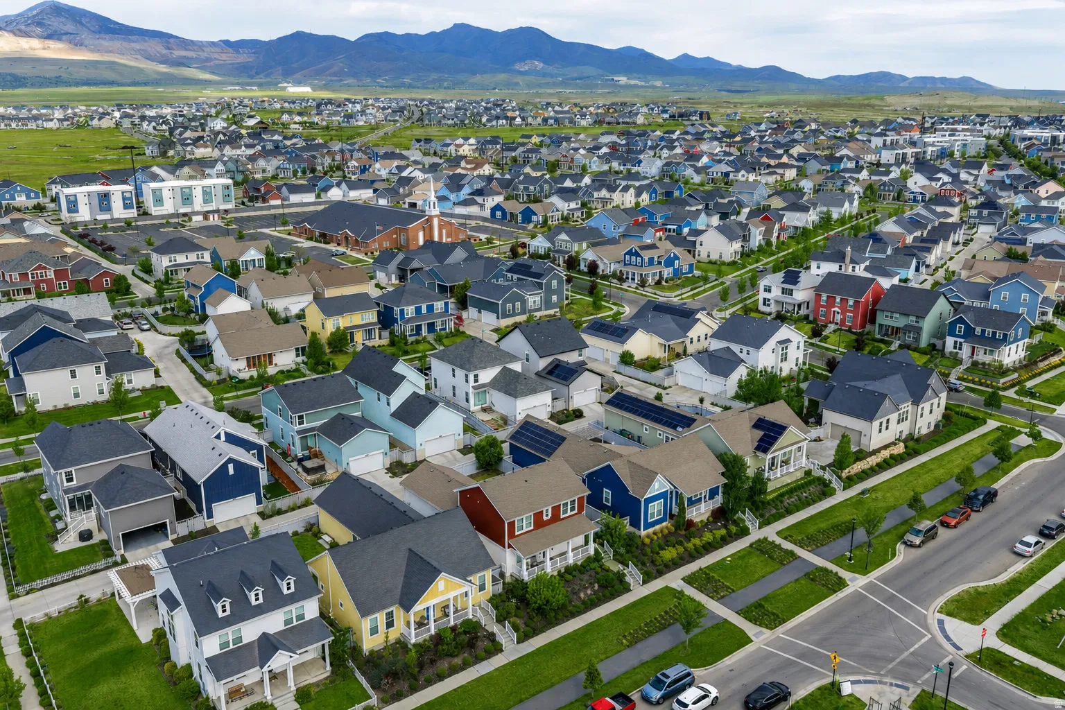 Expansive residential development featuring diverse architectural styles and mountain backdrops