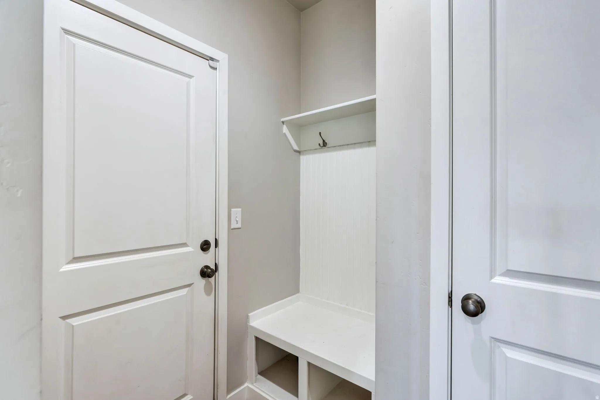Built-in mudroom bench with cubby storage and coat hooks