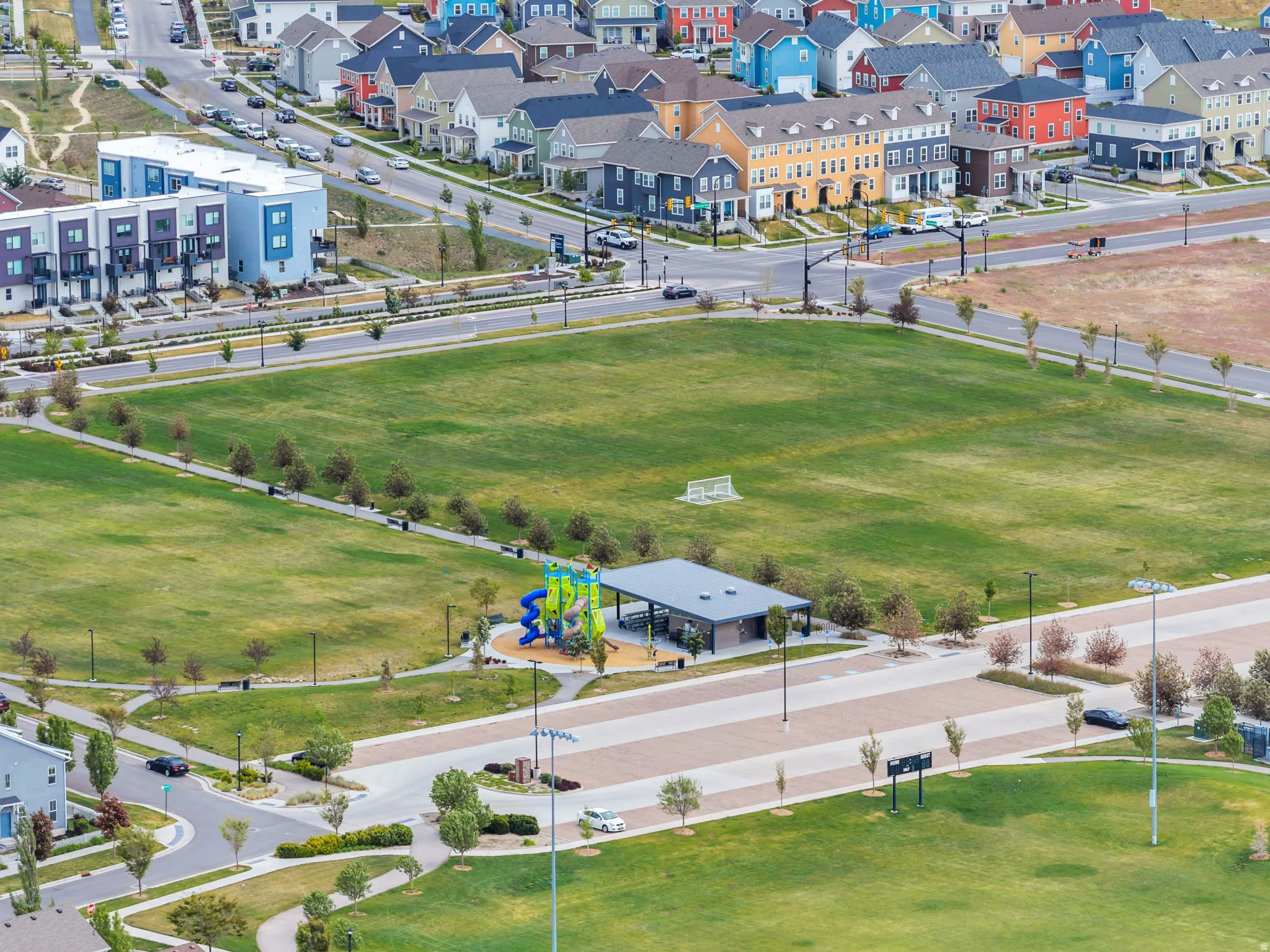 Expansive green space featuring recreational facilities and perimeter walking paths