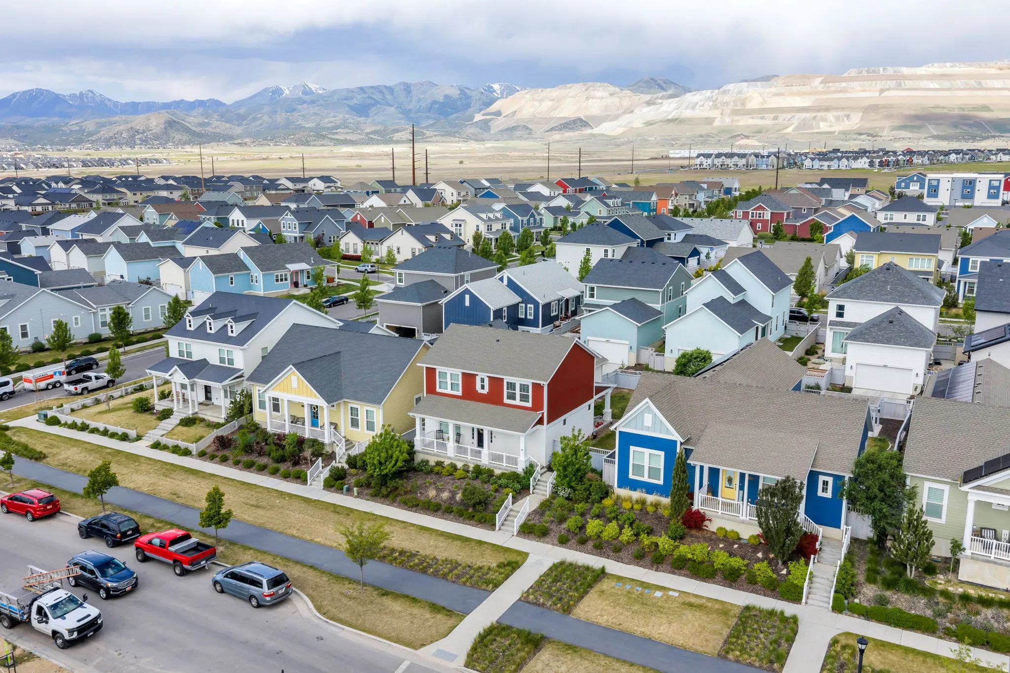Expansive residential neighborhood featuring a variety of single-family homes with diverse exterior colors, paved streets, and sidewalks