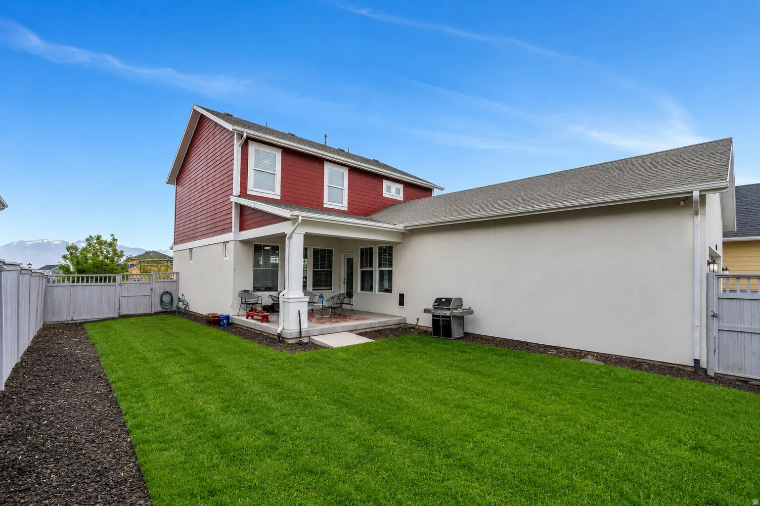 Manicured lawn with a covered patio, and fully fenced.
