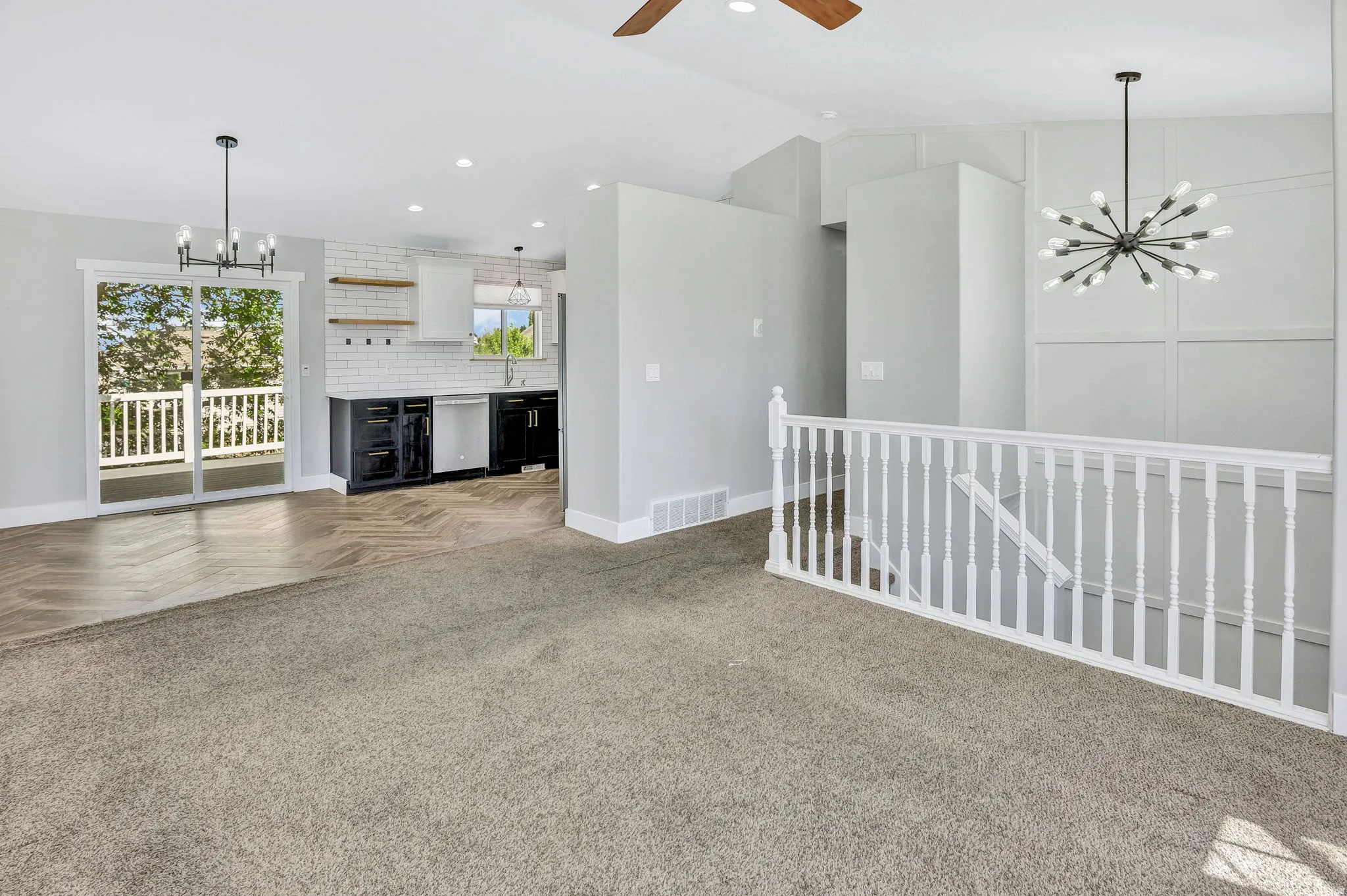 Open-concept living area with vaulted ceilings and a modern Sputnik chandelier
