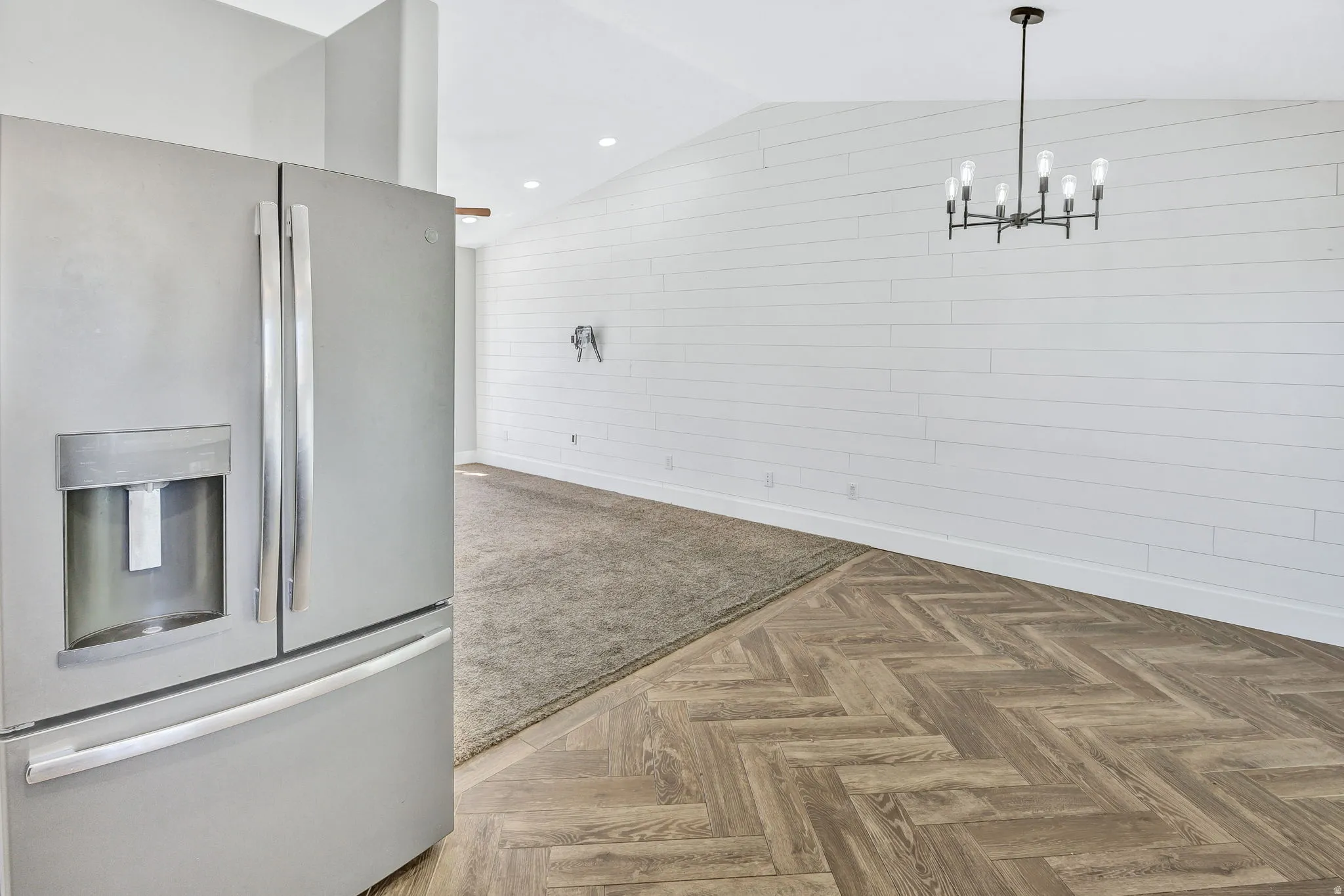 Vaulted ceilings complement the white shiplap wall paneling