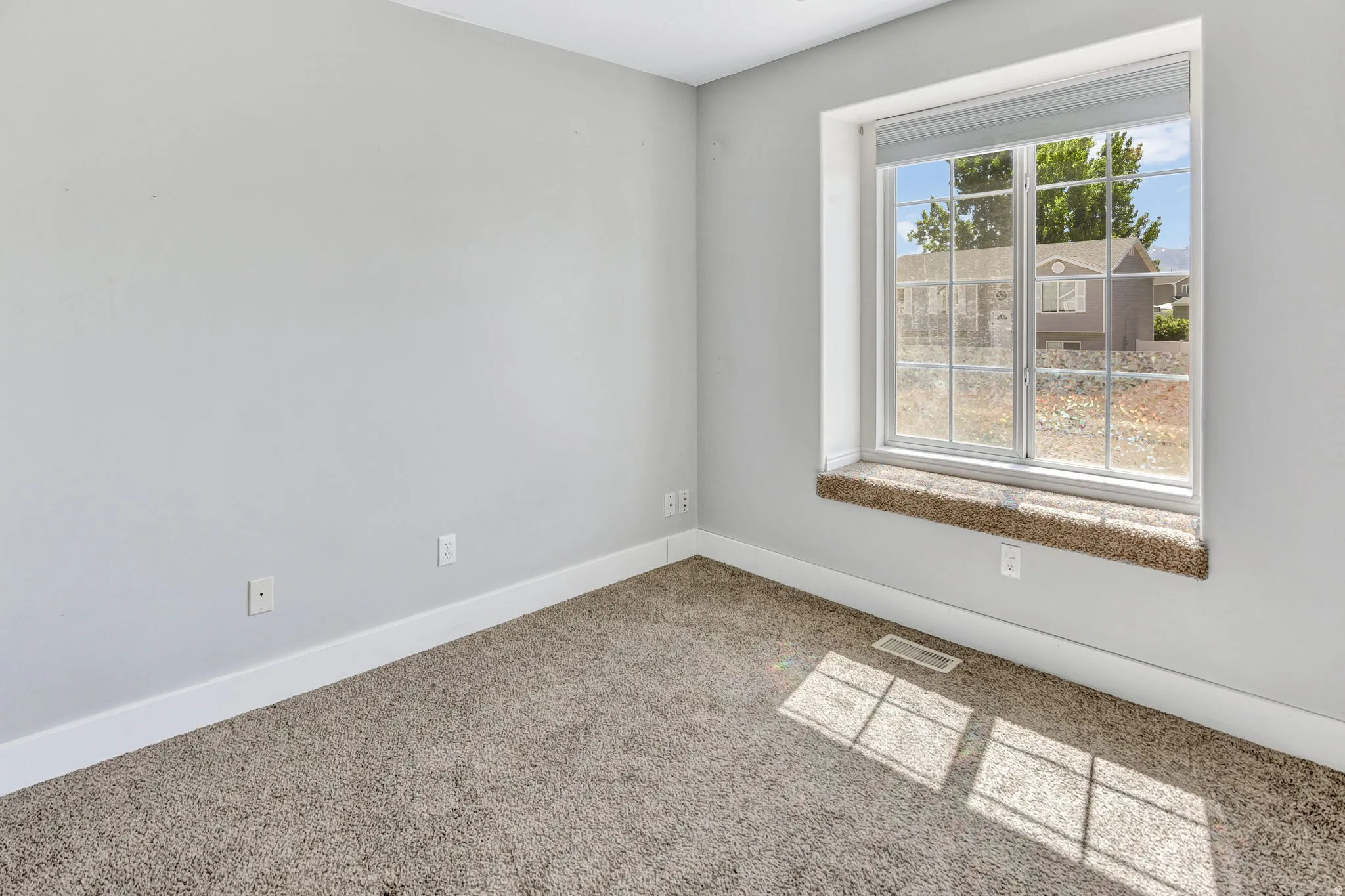 Large multi-pane window with a carpeted sill