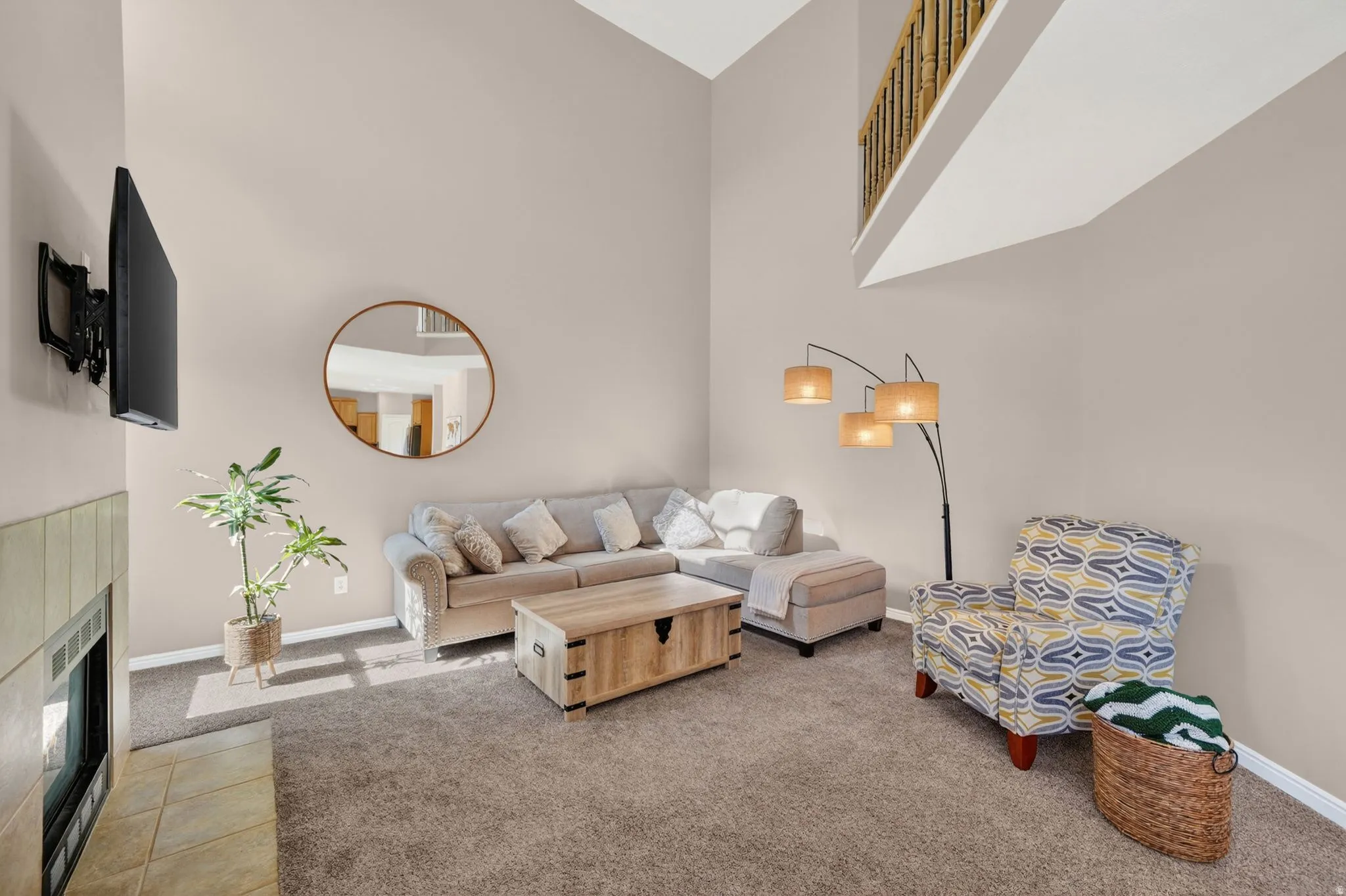 Living area with vaulted ceilings and a built-in fireplace featuring a tile surround