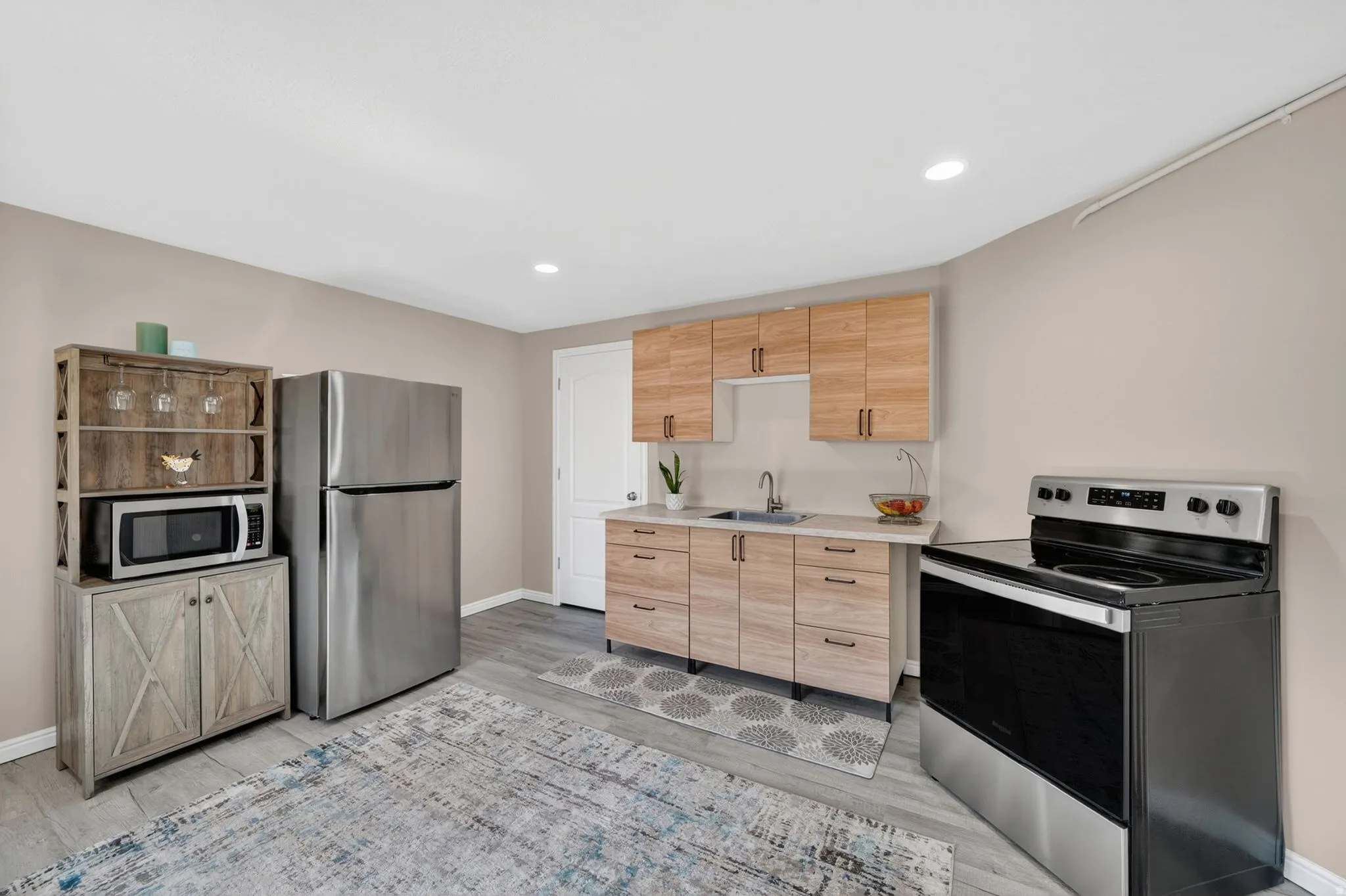 Contemporary kitchen featuring wood-finish cabinetry and light-toned countertops