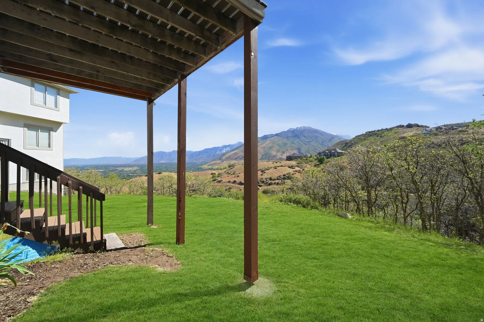 Expansive green lawn with a mountain backdrop
