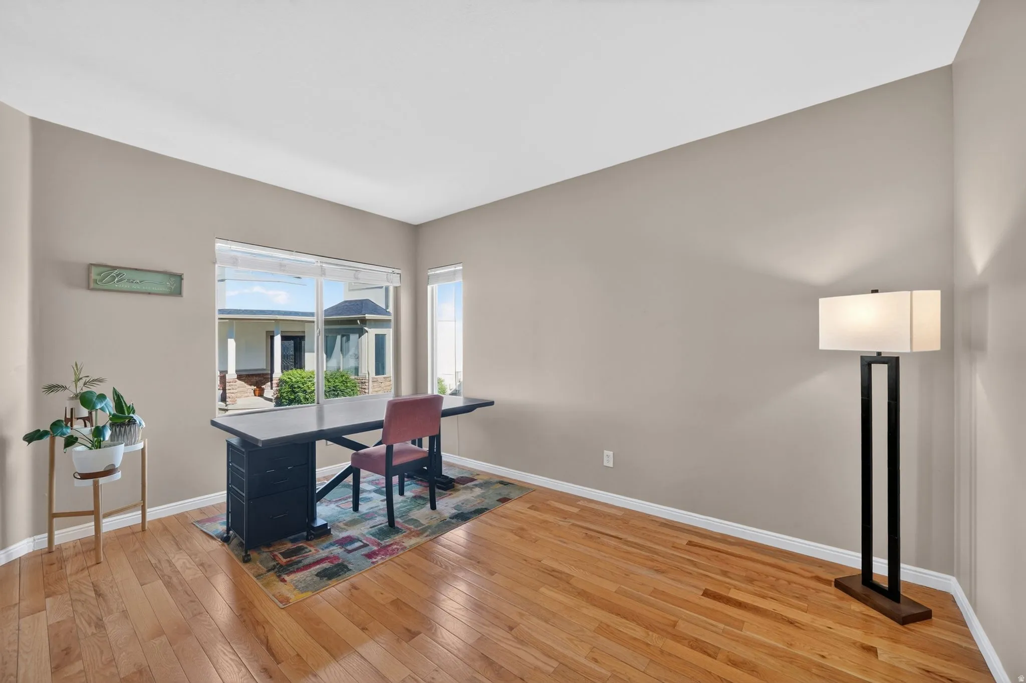 Bright room featuring light-toned walls and wood-finish flooring