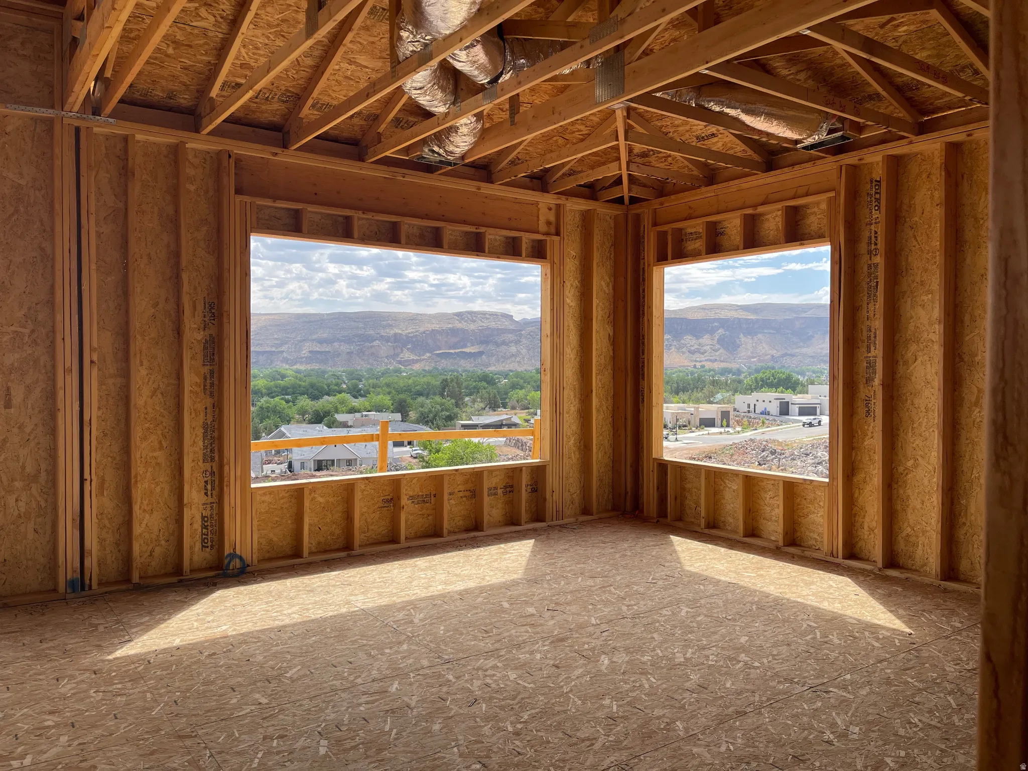 Unfinished interior framing with exposed ceiling joists and subflooring