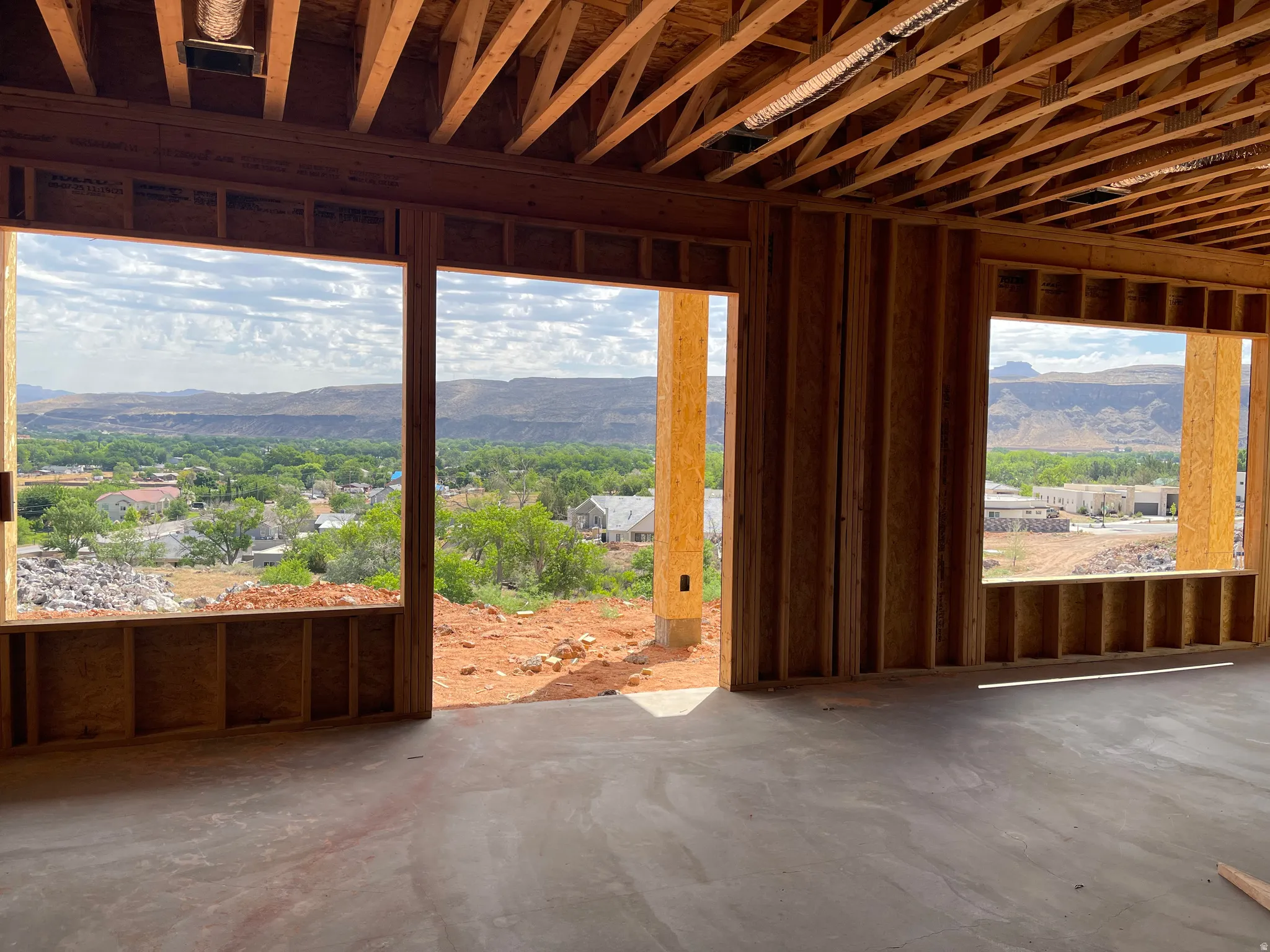 Newly framed interior space with expansive window openings