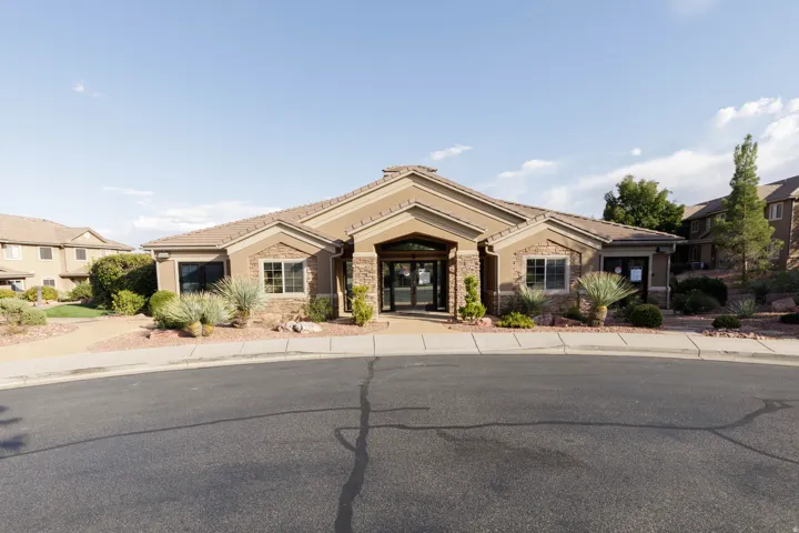 Single-story structure featuring stucco siding and stone accents