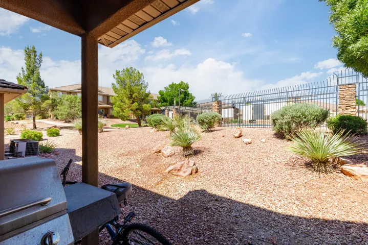 Covered patio space featuring a stucco finish, offering shade from the sun