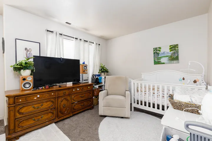 Bright room with light-colored walls and soft gray carpeting