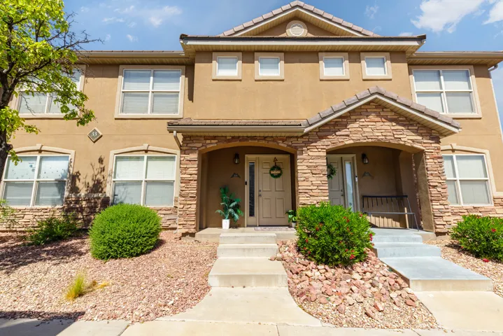 Stucco exterior with stone accents and arched entryways
