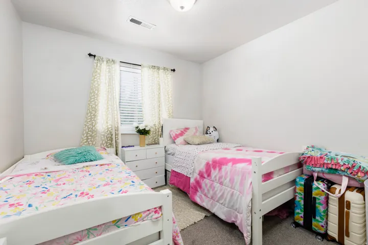 Room featuring white walls, textured carpeting, and a ceiling-mounted light fixture