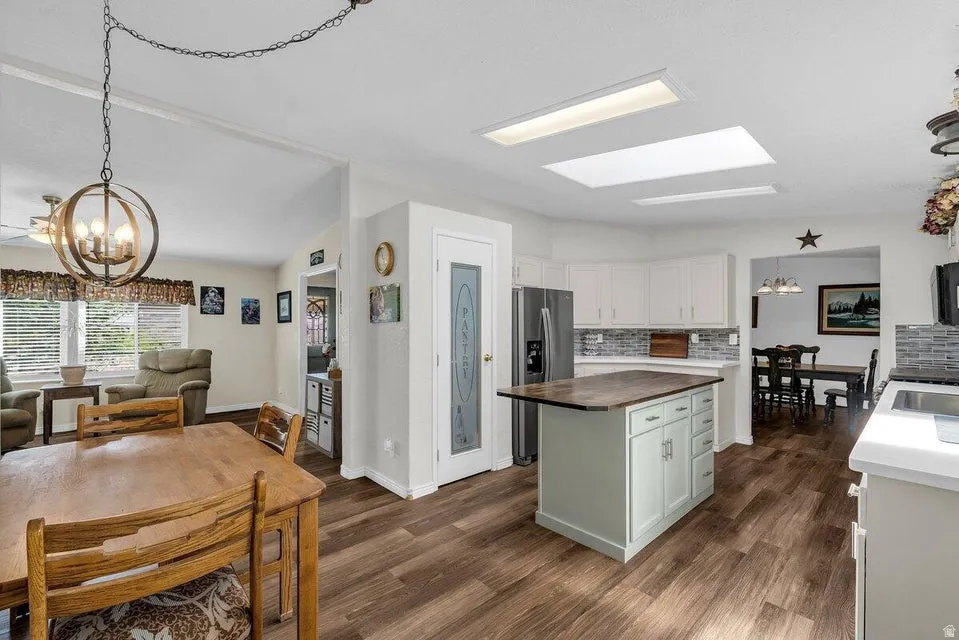 Open concept kitchen and dining area with wood-finish flooring