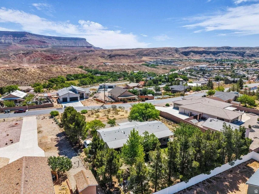 Expansive aerial view showcasing residential properties within a mountainous desert landscape