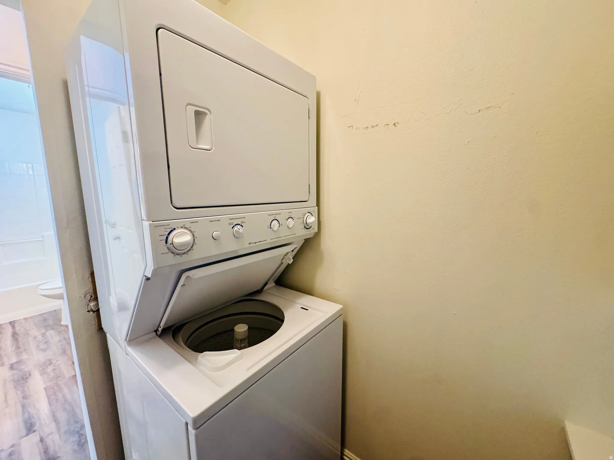Compact stacked washer and dryer unit with top-load washer