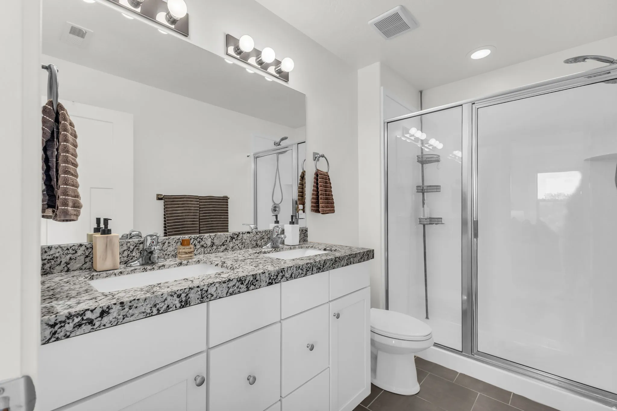 Dual vanity granite countertop and large walk in shower.