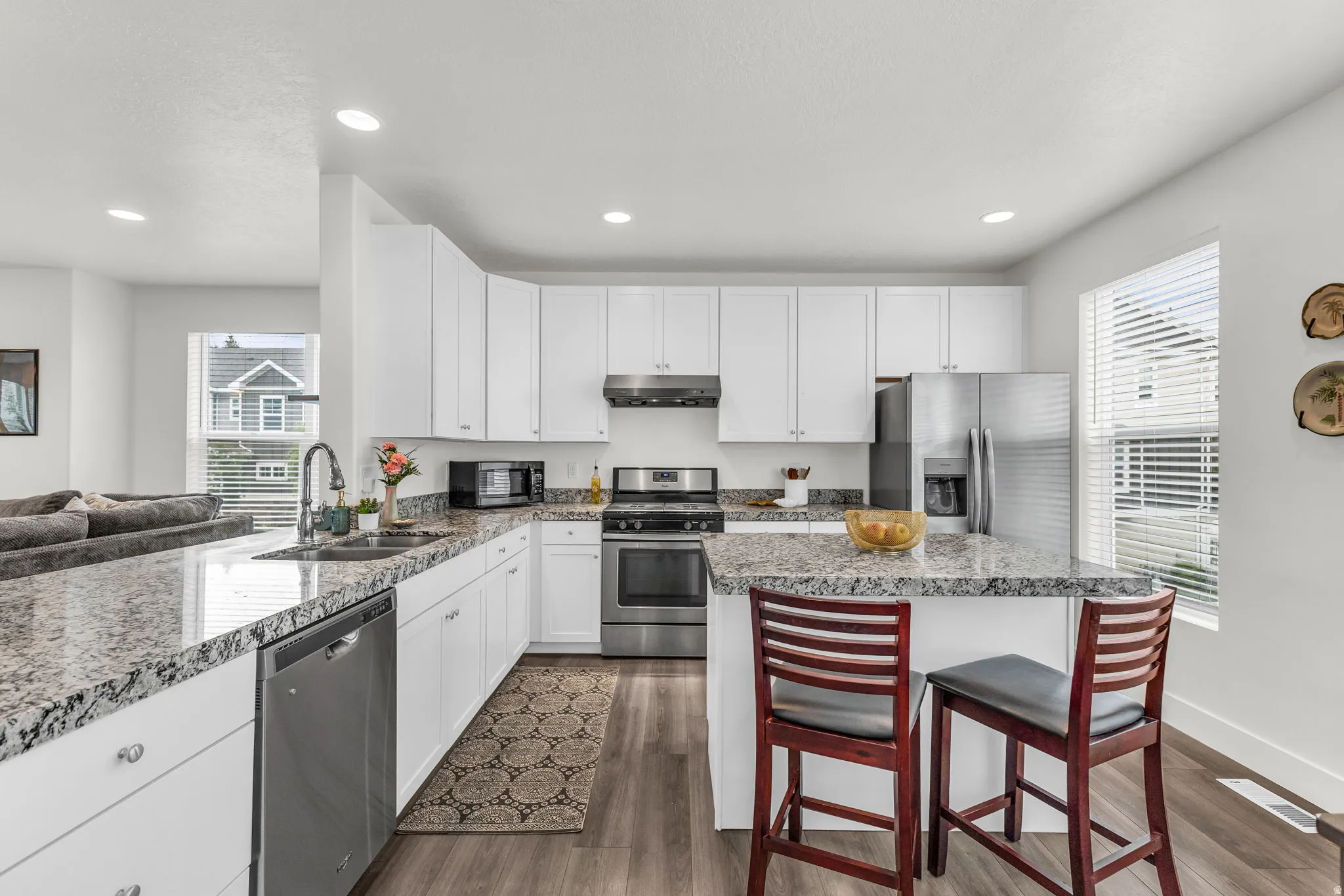 Granite countertops, stainless steel appliances, gas stove and range hood. The kitchen island with seating, and storage!