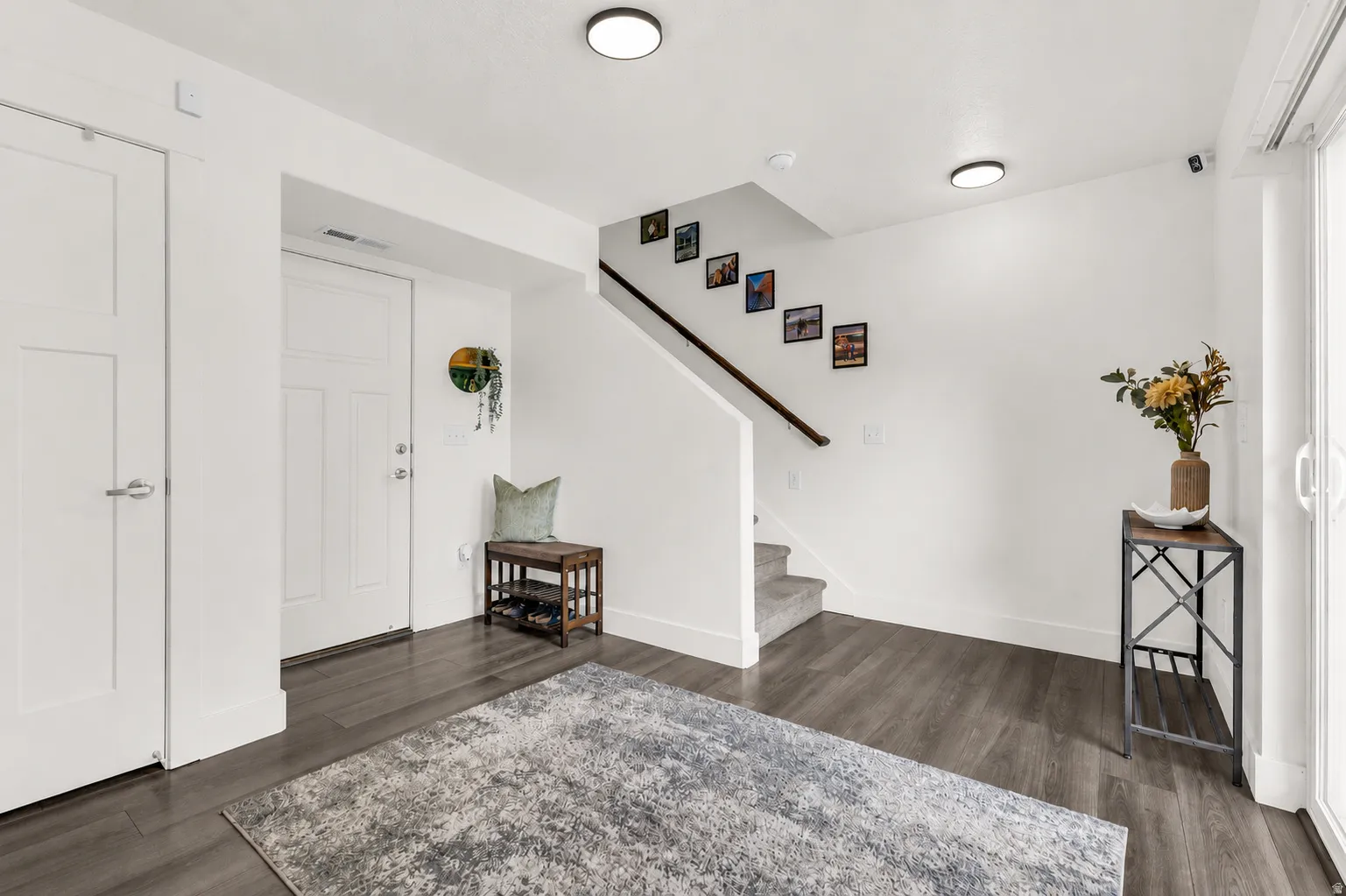 Spacious entry wall with updated LED lighting, garage access, coat closet and utility closet. Sliding glass door opens up to the shady patio.
