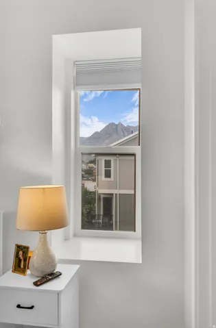 Deep-set window featuring black out blinds and mountain backdrop