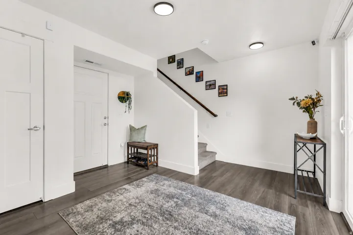 Spacious entry wall with updated LED lighting, garage access, coat closet and utility closet. Sliding glass door opens up to the shady patio.