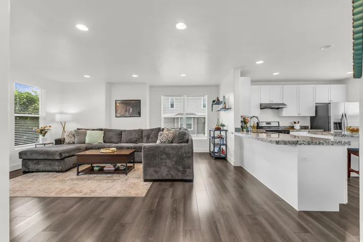 Open-concept living space with kitchen bar for added seating