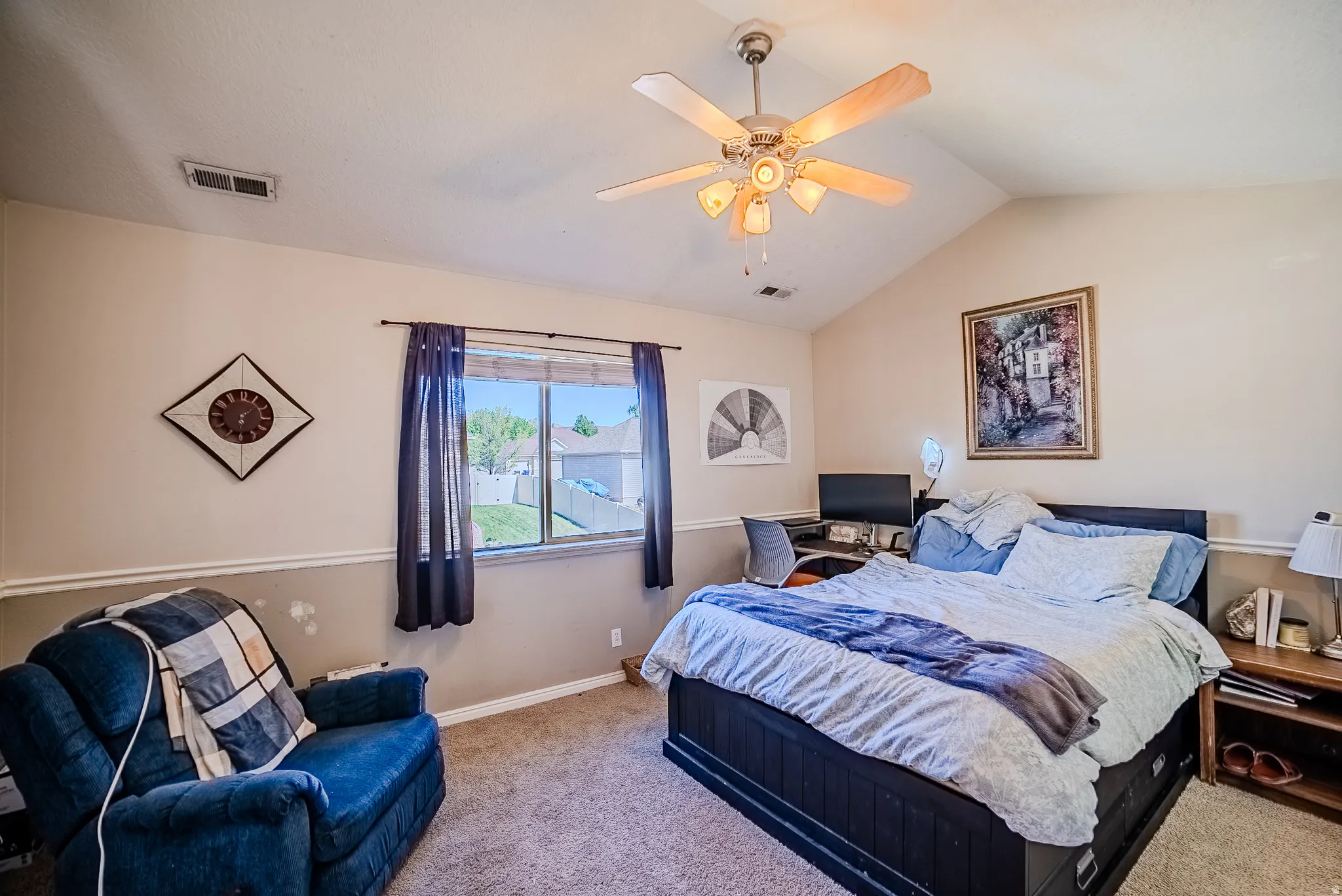 Bedroom featuring vaulted ceilings and a ceiling fan with integrated lighting