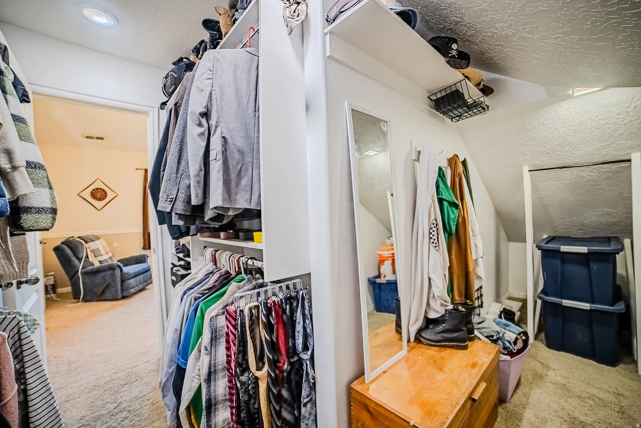 Custom closet organization system featuring hanging rods and upper shelving