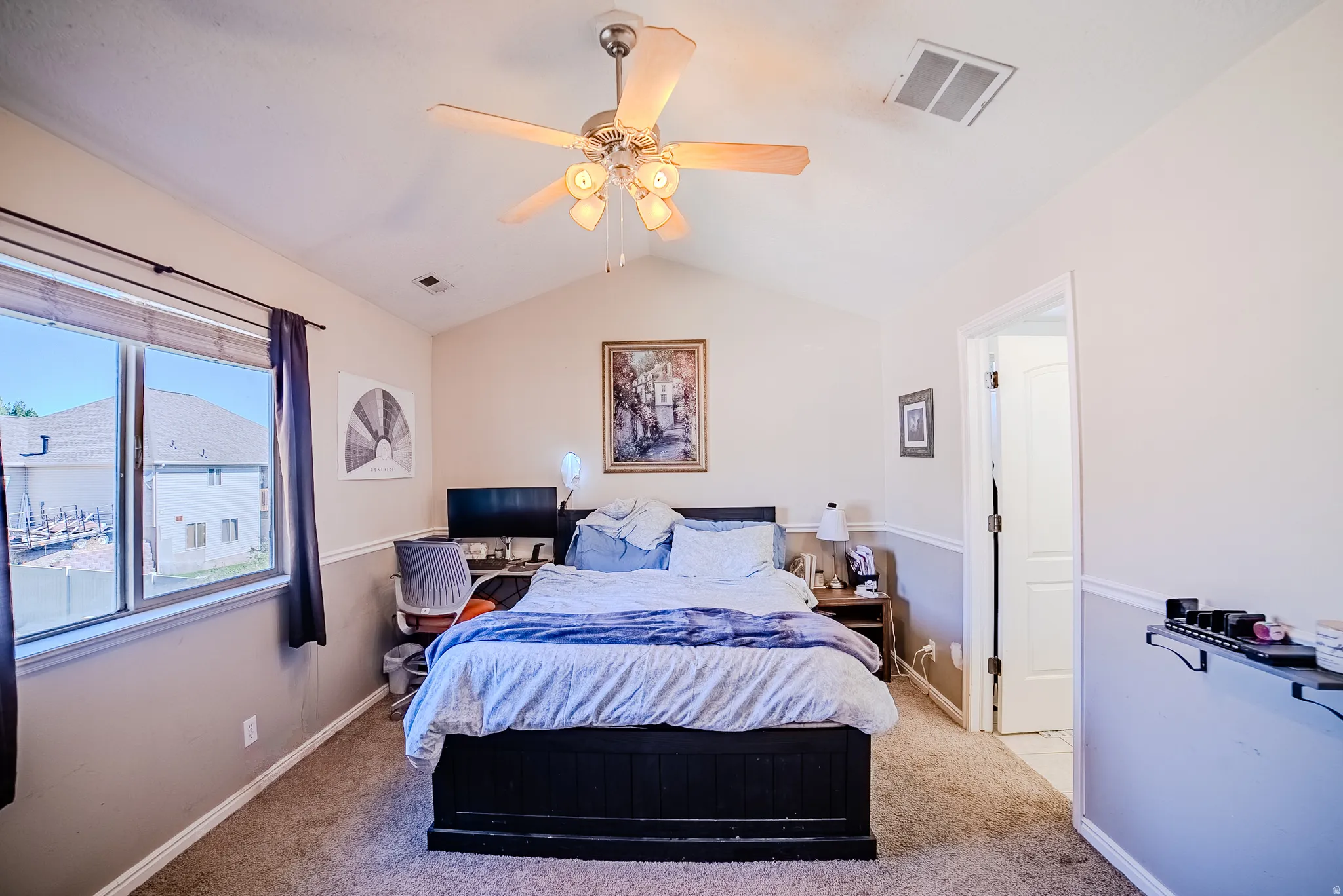 Vaulted ceiling room featuring a ceiling fan with integrated lighting, a large window with blinds, and white trim molding
