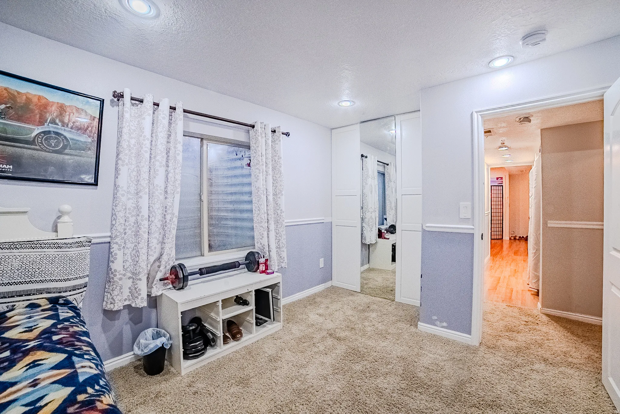 Carpeted interior room featuring recessed lighting and a chair rail molding