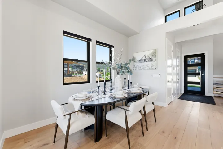 Light wood-finish flooring complements the white walls and high ceilings