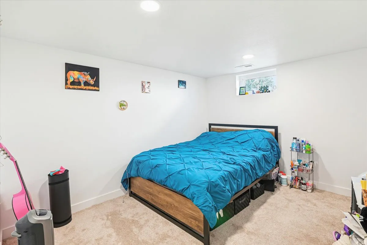 Spacious room with plush carpet flooring and clean white walls