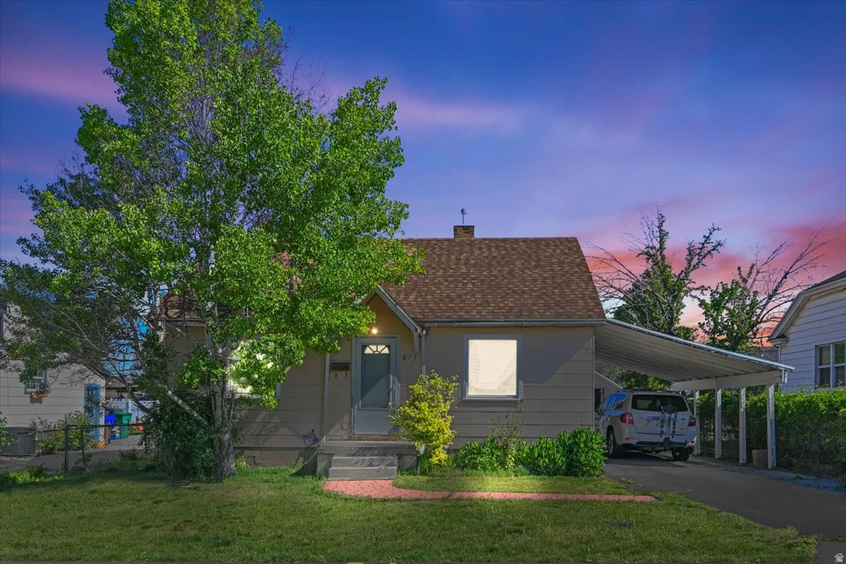 Single-story residence featuring a covered front porch and a carport