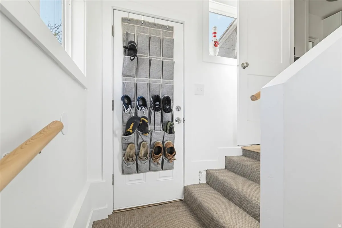 White interior walls with a light wood-finish handrail