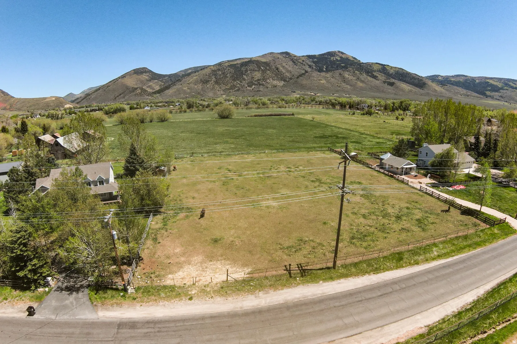Expansive land parcel featuring open fields and distant mountain scenery