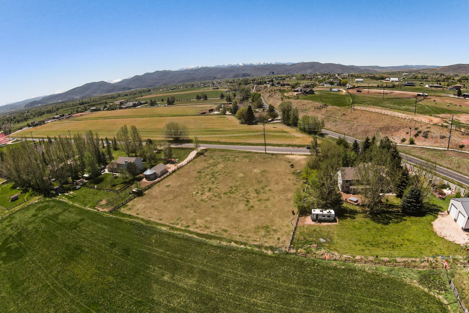 Expansive land parcel featuring open fields and mature trees