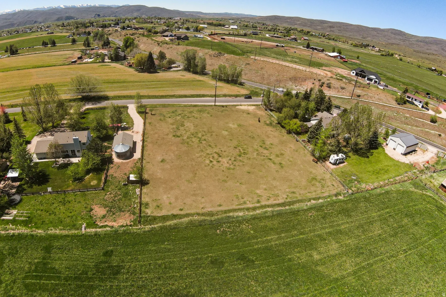 Expansive land parcel featuring a large grassy area and distant mountain range