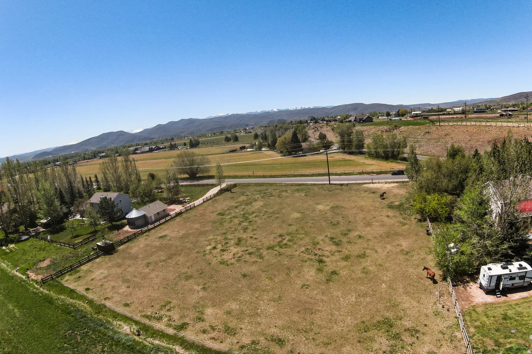 Expansive open pastureland with distant mountain ranges