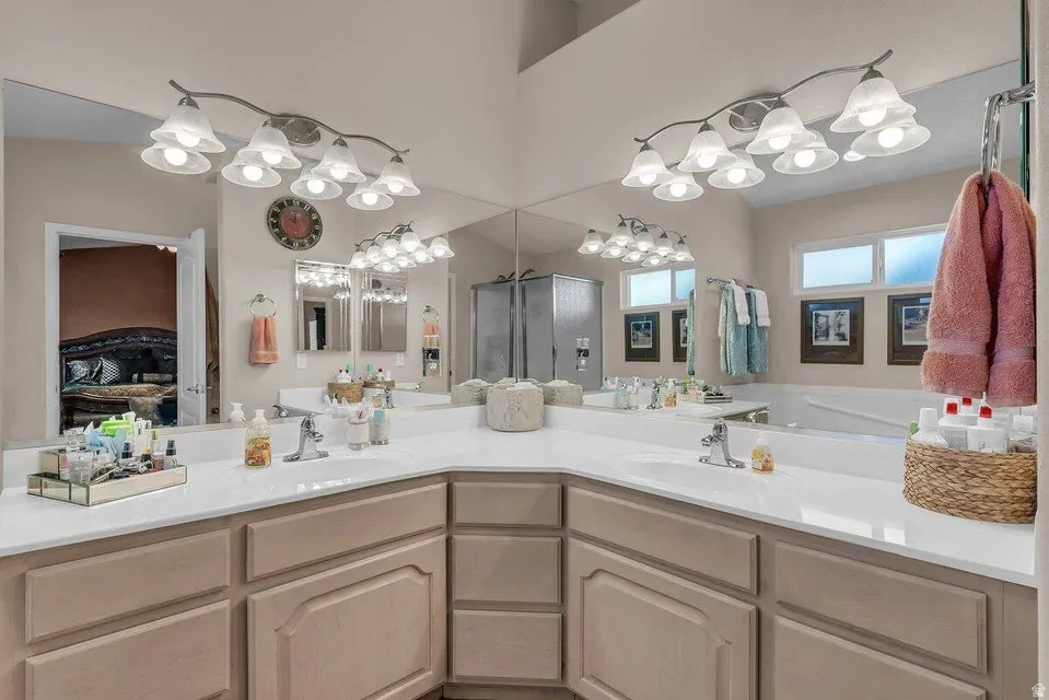 Dual vanity with white countertops and light-toned cabinetry