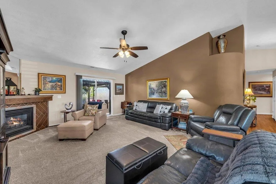 Spacious living area featuring a corner fireplace with a tile surround and wood mantel