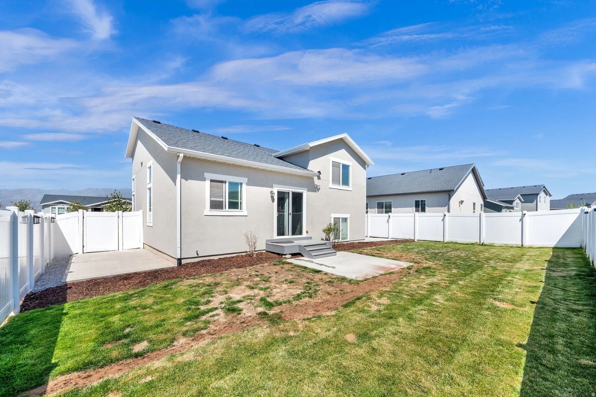 Fully fenced backyard with concrete patio
