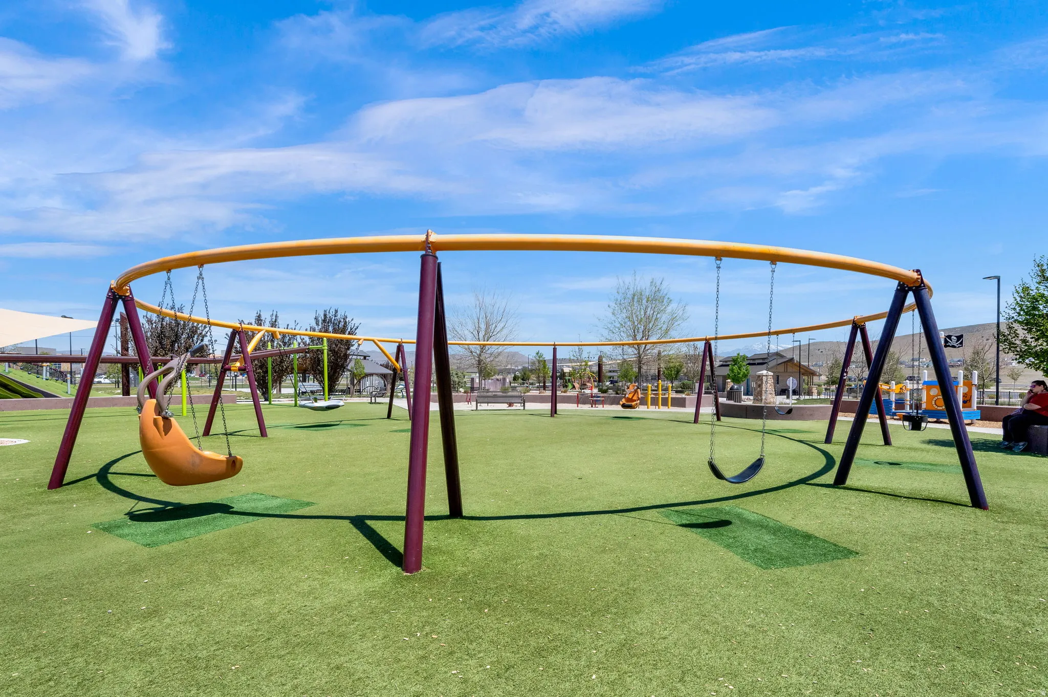 Community playground featuring multiple swing sets