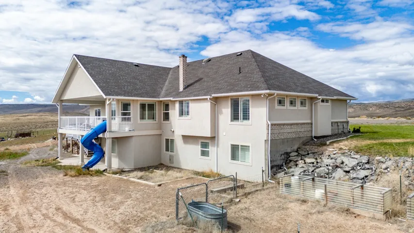 Two-story residential structure featuring a covered upper-level deck