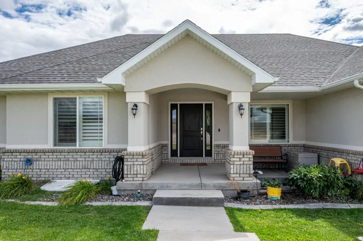 Welcoming stucco exterior with a prominent covered entryway