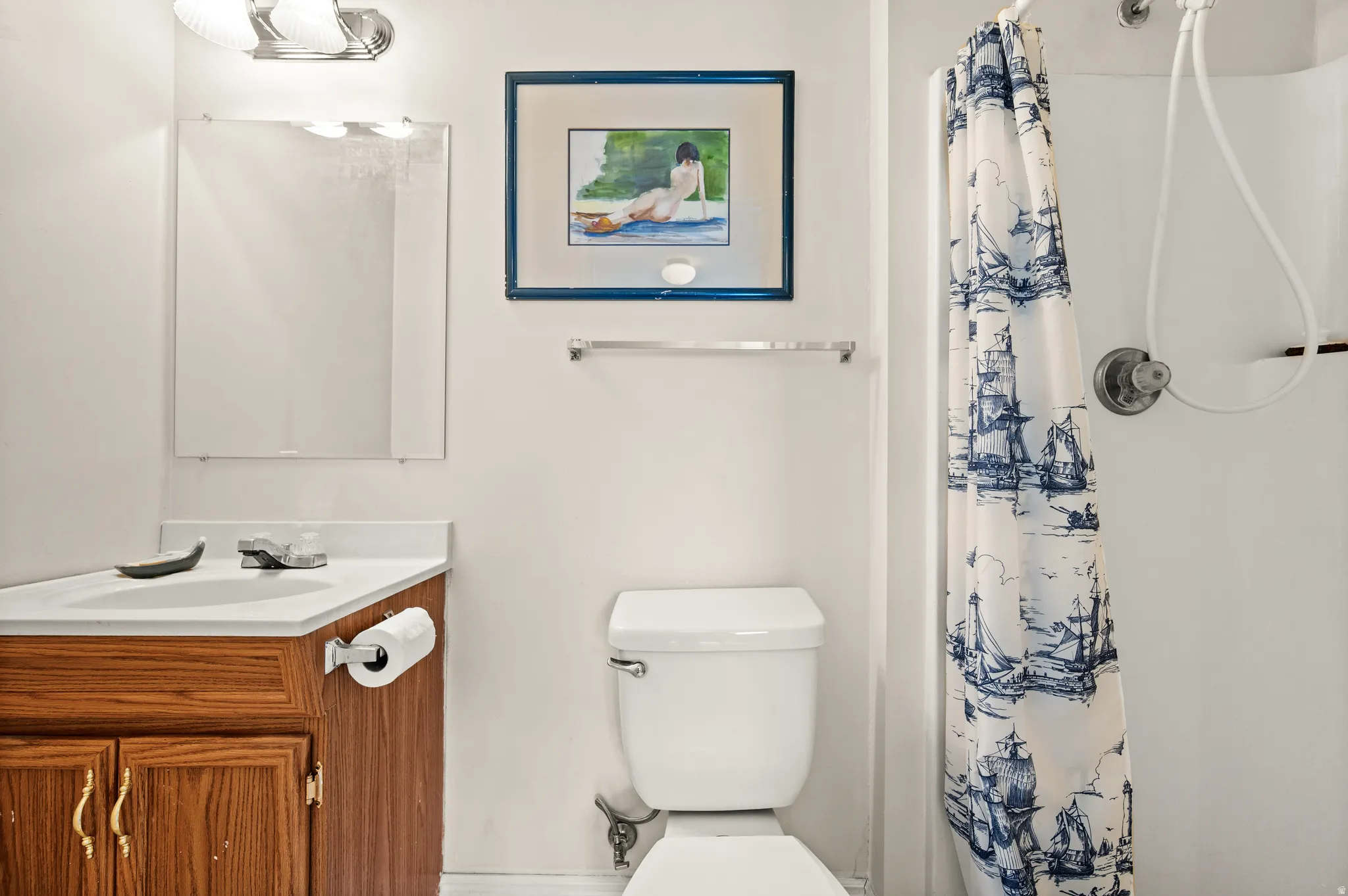 Bathroom vanity with a white countertop and wood-finish cabinetry