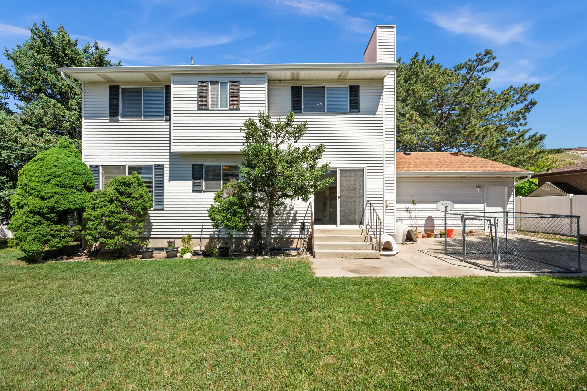 Spacious lawn and concrete patio area featuring direct access to the interior